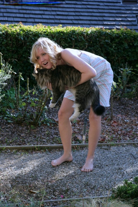 Blonde teen Kimber Clarkson hangs onto her cat before showing her tight slit