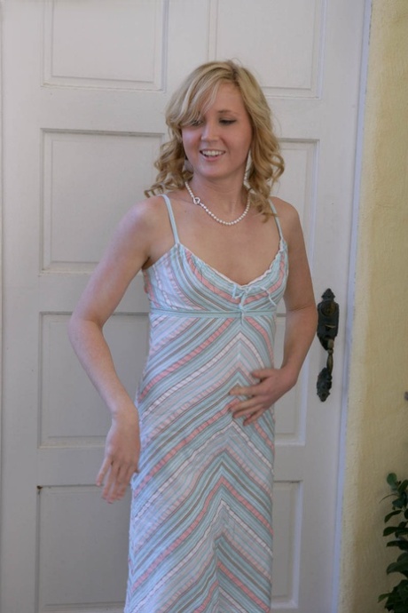 Blonde teen Kimber Clarkson hangs onto her cat before showing her tight slit