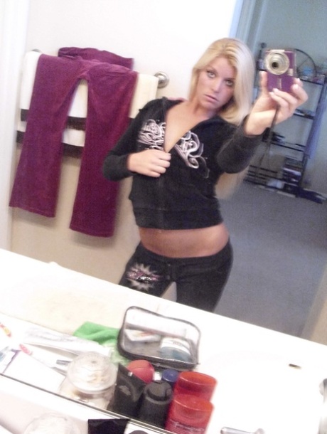 Blonde amateur Lena Scotte takes selfies of her small tits and bald slit