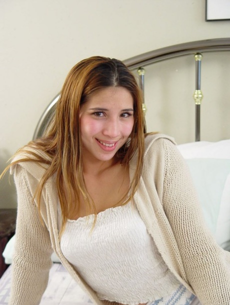 Petite teen slowly removes her clothes until she's totally naked on her bed