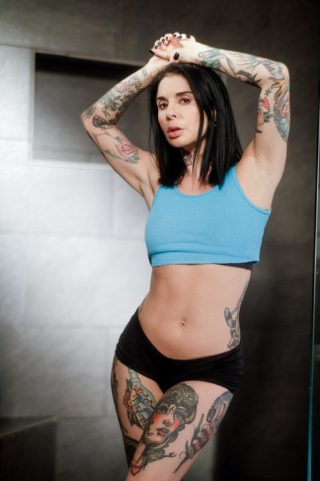 Tattooed solo girl Joanna Angel finger spreads her pussy in sports socks