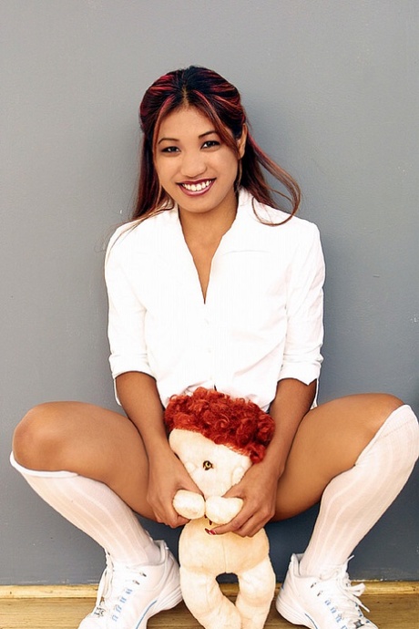Indian teen holds a stuffed animal while revealing her vagina