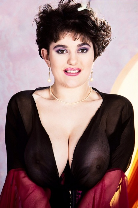 Short haired female Ingrid licks a nipple after loosing her large boobs