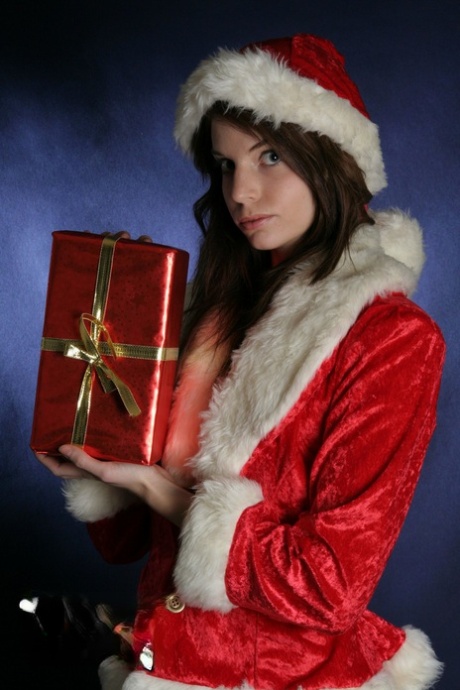 Natural redhead Diana S removes Christmas clothing for her first nude shoot