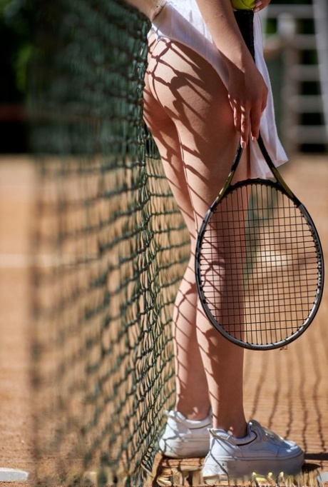 Pretty brunette teen Elena Max flashes her pussy while playing tennis