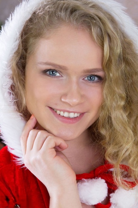 Cute teen girl doffs her Christmas outfit for nude posing over the holidays