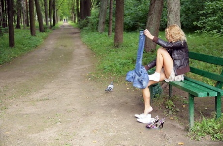 Cute teen with blonde hair Summer Breeze shows her naked body on park bench