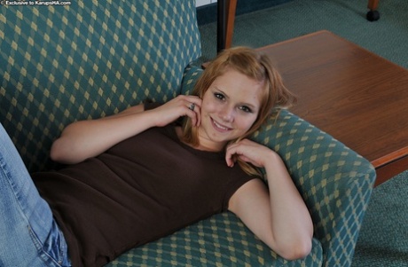 Gorgeous teen beauty Brittny is showing her tight pussy on a couch