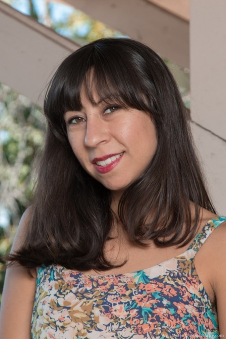 Latina Vivi Marie revealing her mature shaggy pussy on the balcony