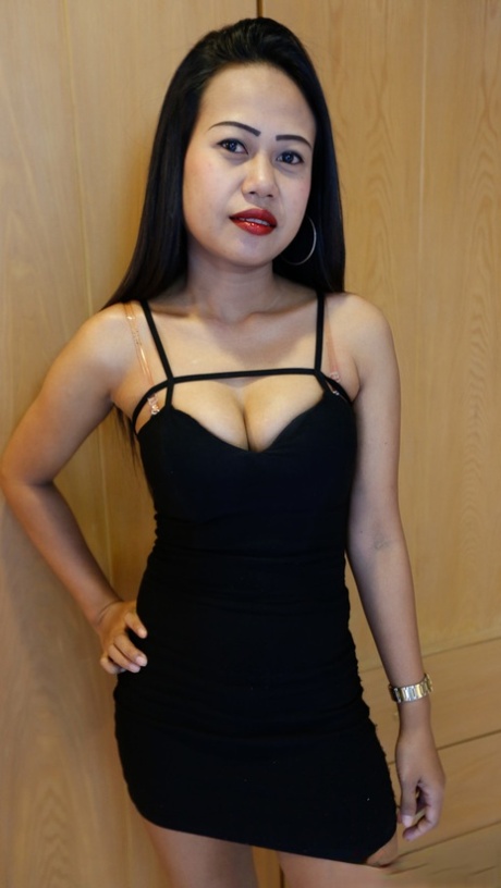 Slim Thai female removes her little black dress for her first nude poses