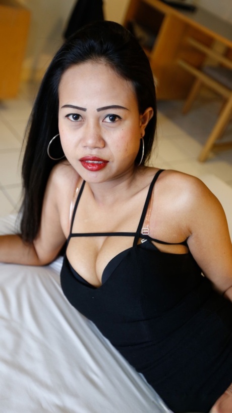 Slim Thai female removes her little black dress for her first nude poses