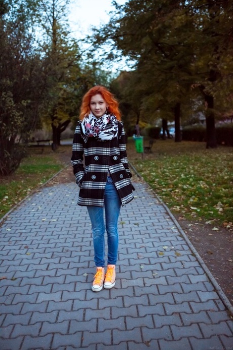 Skinny redheaded babe Ambre doffs her clothes and poses nude in a solo