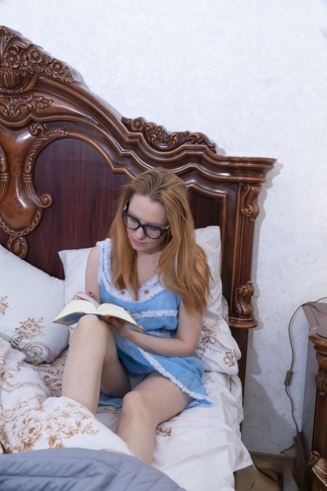 Cute amateur girl Katya exposes her hairy pussy and spreads it on a bed