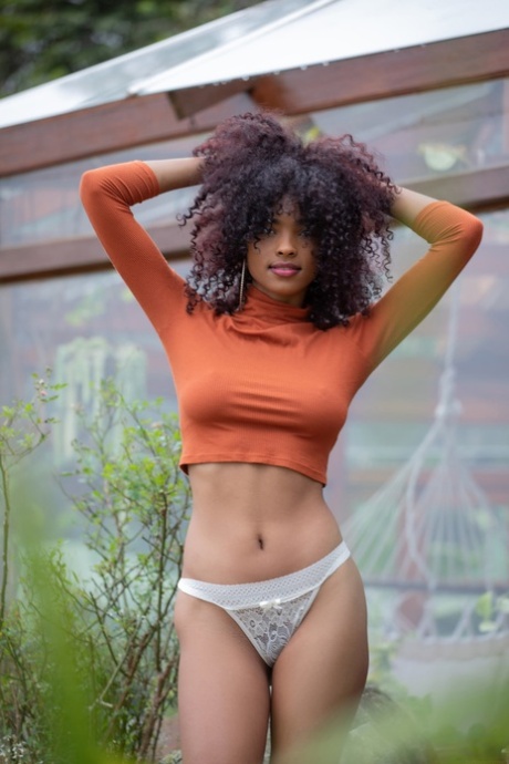 Curly haired teen Barbie flaunts her incredible butt while stripping outdoors
