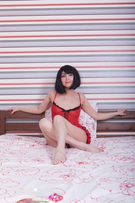 Enchanting amateur Milada peels off her red lingerie to show her hairy pussy