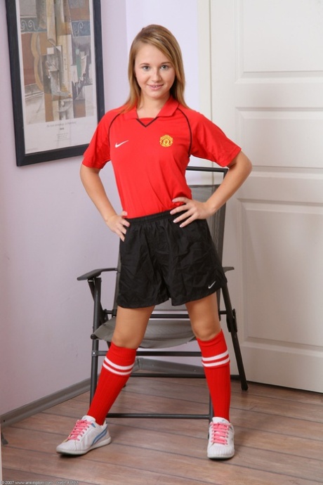 Petite soccer player Olga takes off her uniform & spreads her shaved pussy